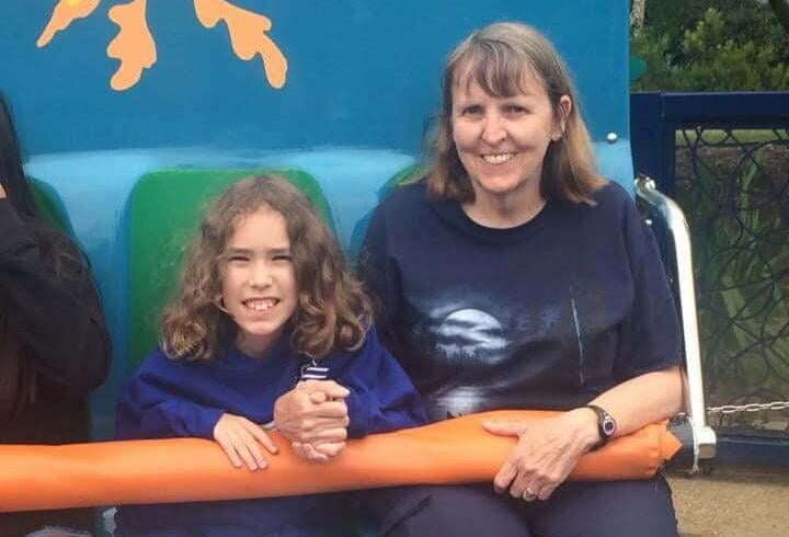 A grandmother and grandson on an amusement park ride
